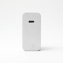 A light gray marble-textured phone case with a rounded rectangular shape and a horizontal cutout near the top, shown on a clean white background.