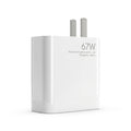A white Xiaomi 67W wall charger with two silver metal pins, shown on a clean white background. The front of the charger features the text '67W', 'Xiaomi Communications Co.