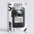 A 120W power bank in its retail packaging, featuring a black device with a built-in cable inside a clear plastic window on a white box with black graphic accents.